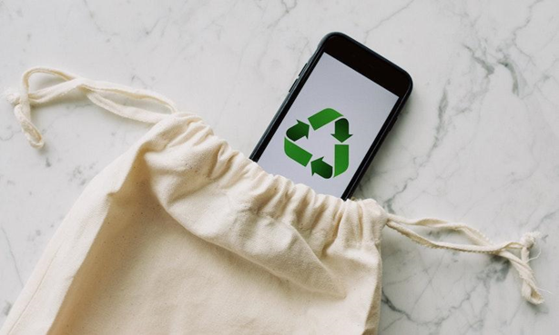 Eco-friendly bag and recycle logo on the phono can be motivation for traveling light on your next eco-adventure.
