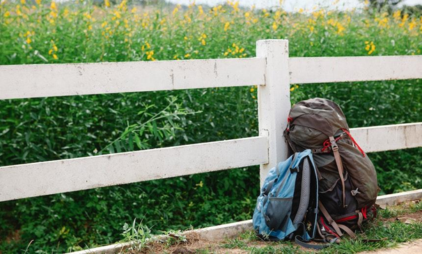 Rucksack leaned on a fence.