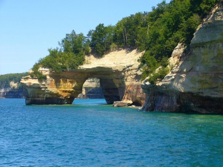 a colored rocky cave on the lake