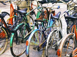 Colorful bikes parked in street in Bologna, Italy