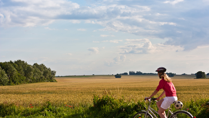 Woman on bike surrounded by nature