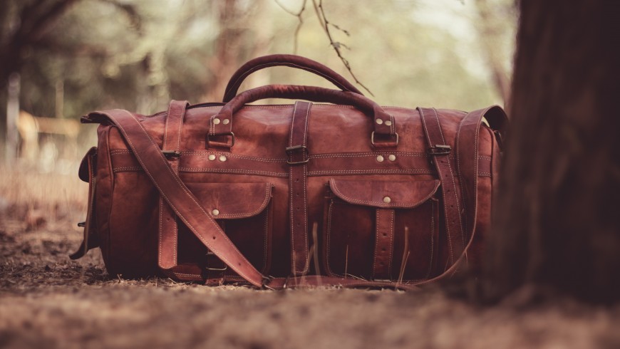 brown luggage - the first tip to travel in an eco-friendly way is to reduce your luggage