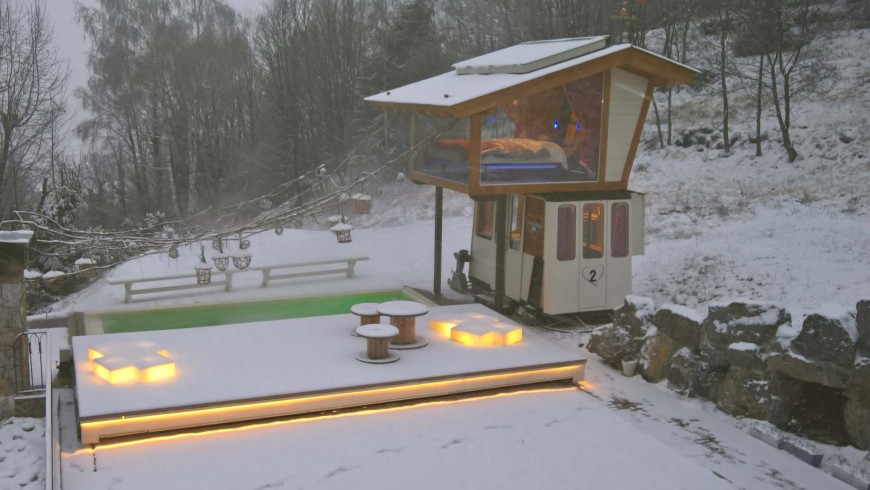 The old cable car, surrounded by snow, transformed into an unusual and green suite