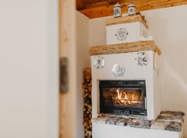the fireplace of the eco-chalet in Trentino