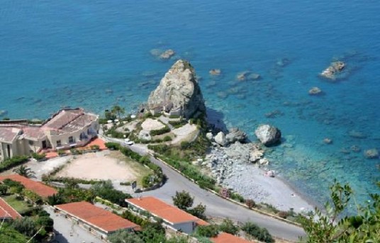 Aerial view on the village of Amantea, on the Tirreno Sea, with limpid water and a big rock near the coast