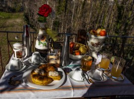 Table with food for breakfast and flowers, everything from the garden in the estate