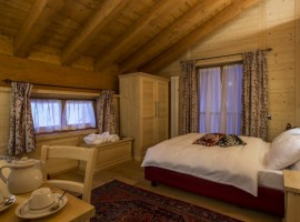 One of the rooms, furnished with wood and a king size bed