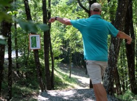 a man throwing his shot among trees