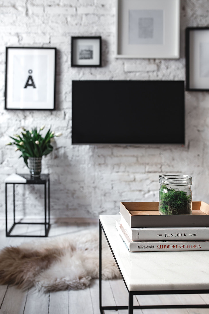White coffee table with plants and books