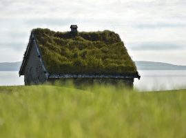 Stone house with a green roof