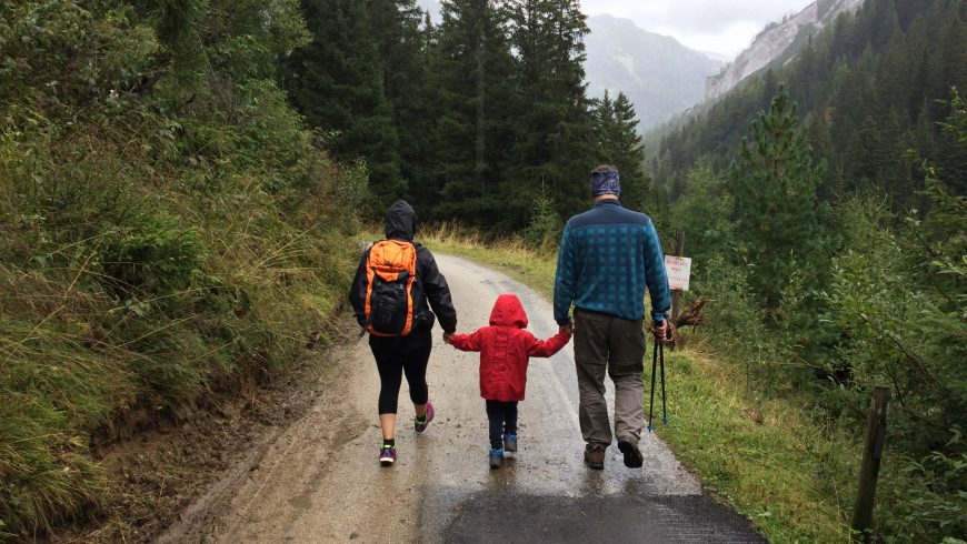 A family hiking on a mountain road