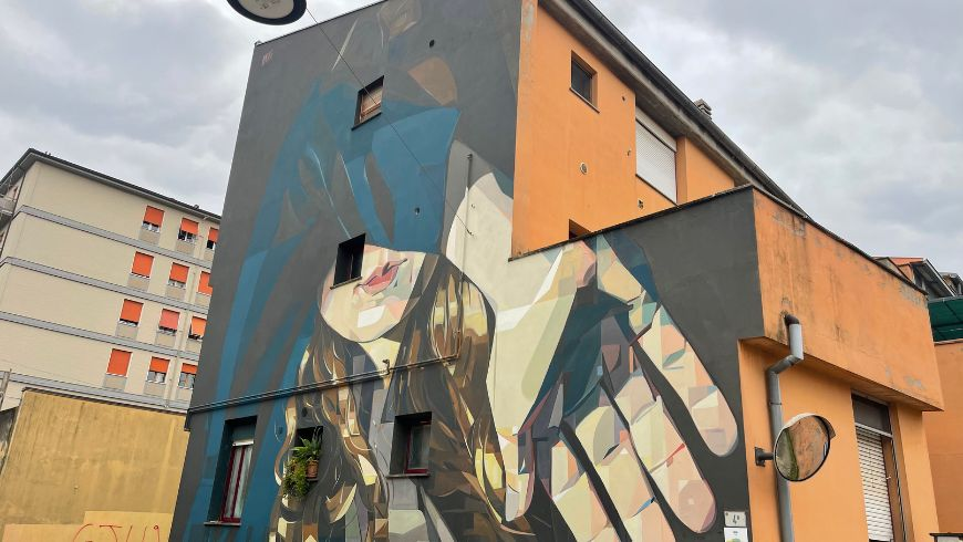 Mural by Basik of a girl covering the face with her hand 