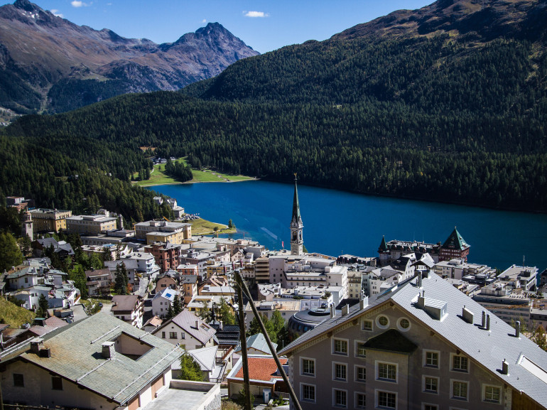 the city of st.moritz watching down on the lake