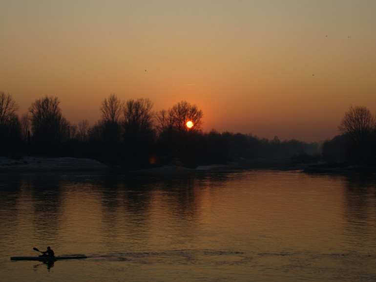 Sunset at Po River. A canoeist breaks into this quiet scenary