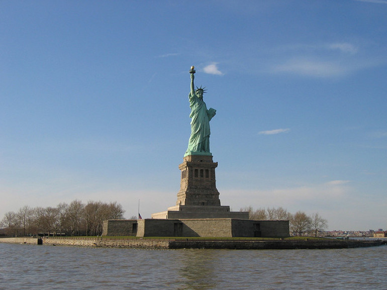 the famous liberty statue on the island surrounded by the sea