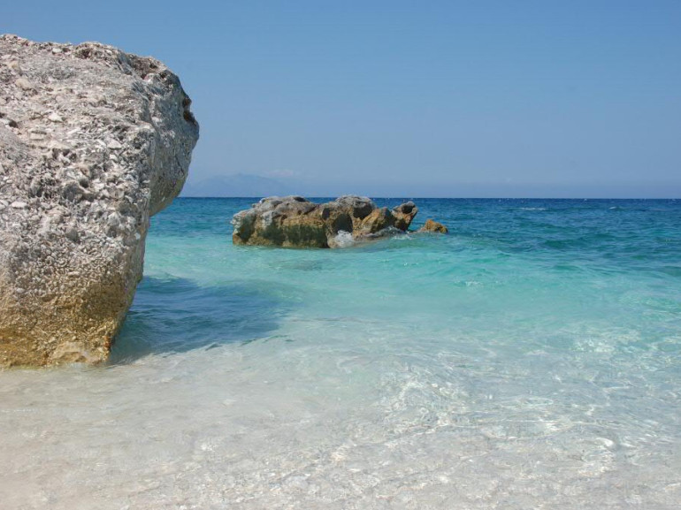 A beach in Sardinia: clear water and rocks 