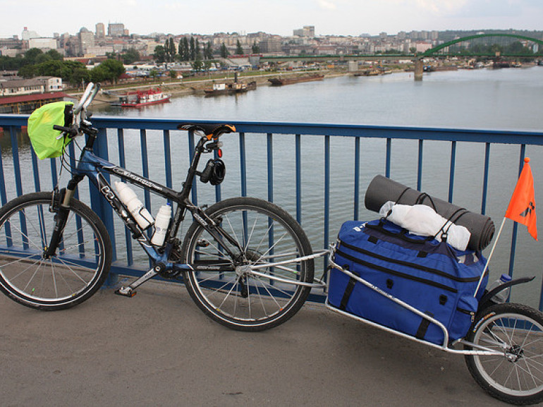 a bike on a bridge. it's the danubio bridge with the city in the surroundings