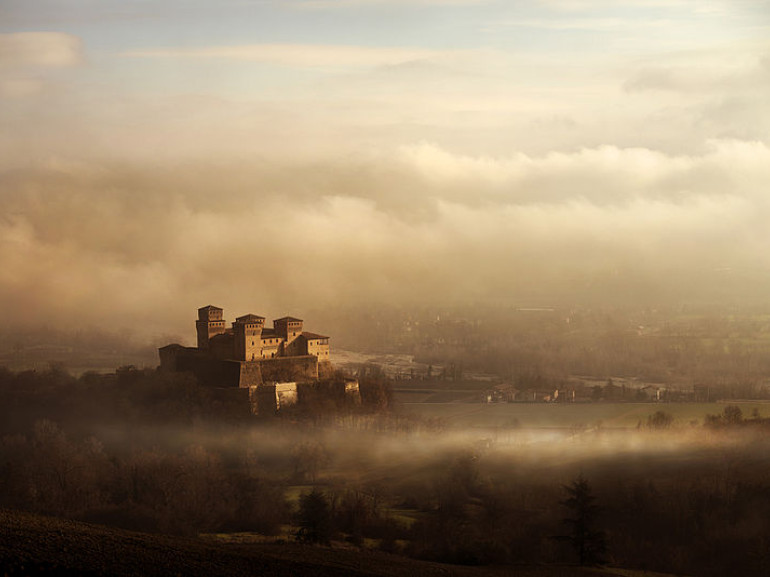 The Torrechiara castle surrounded by fog, Langhirano, Italy