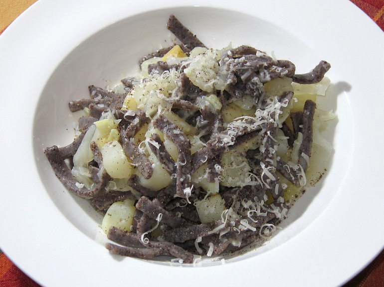 a plate of typical pizzoccheri with cabbage and potatoes