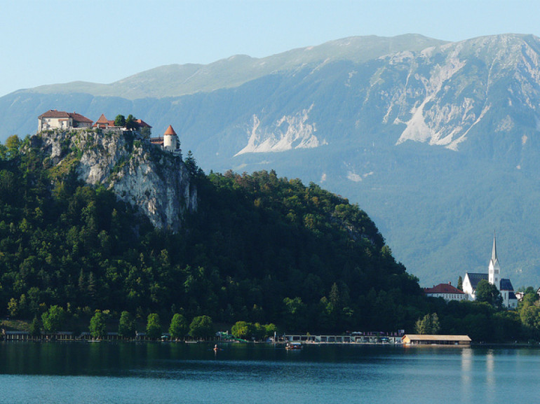 the castel on the rock above the lake and surrounded by trees