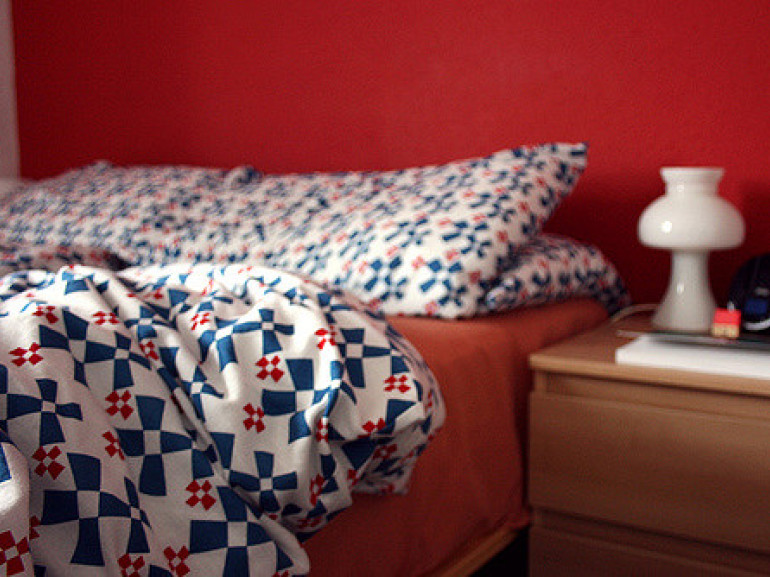 a bed with sheets and a pillow
