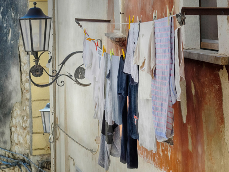 the wall of an house: clothes hanging out of the window