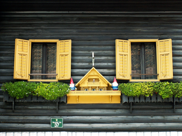 the wooden wall of an house with yellow balconies