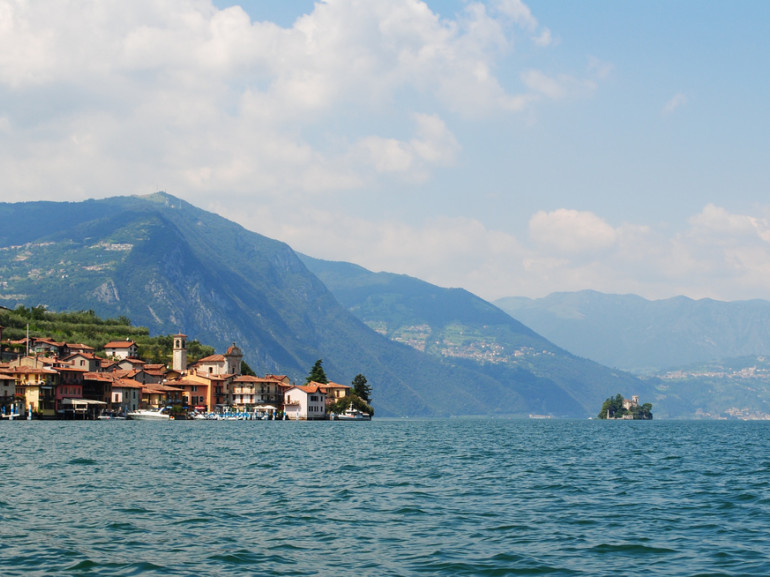 iseo lake with mountains on the background and a city near the coast