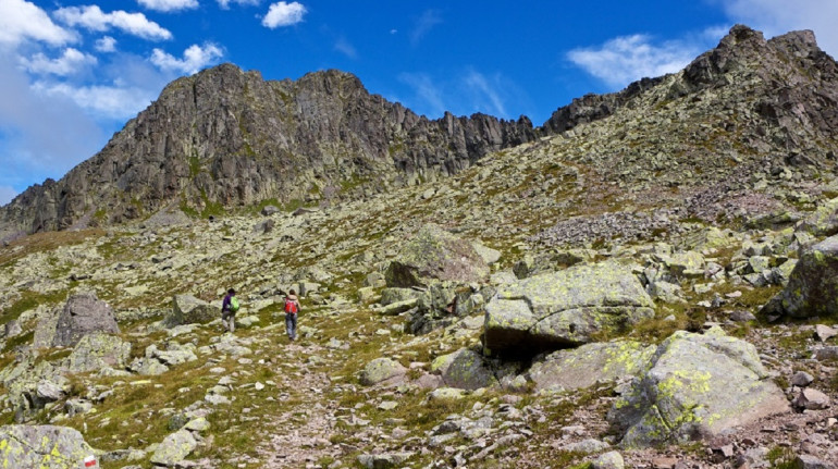the rocky path towards the top and two people walking on it
