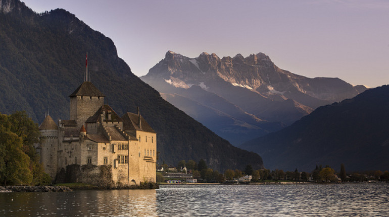 the castel of chillon on the lake with mountains in the back