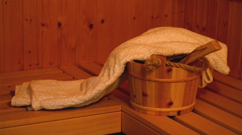 in a sauna: a bucket and a towel
